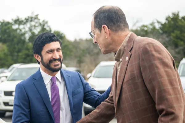 Congressman Greg Casar shakes hands with Texas AFL-CIO President Rick Levy.