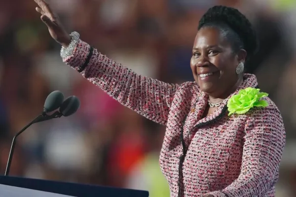Sheila Jackson Lee waves to a crowd during a speech.