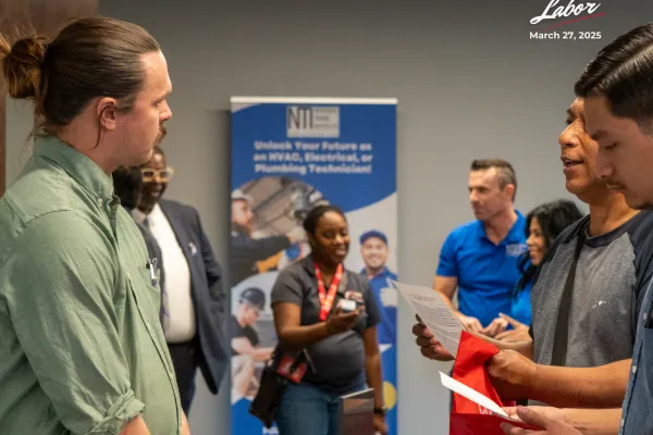 Attendees talk to a UA representative at the career fair