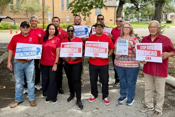 CWA District 6 members, officers, retirees, and constituents from U.S. Congressional District 15 pose for a group photo. They are holding signs demanding a stop to healthcare and medicaid cuts.