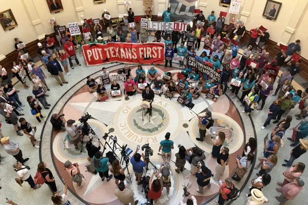 Texans gathered in the Texas Capitol rotunda to protest the Texas House's passing of mid-decade redistricting maps