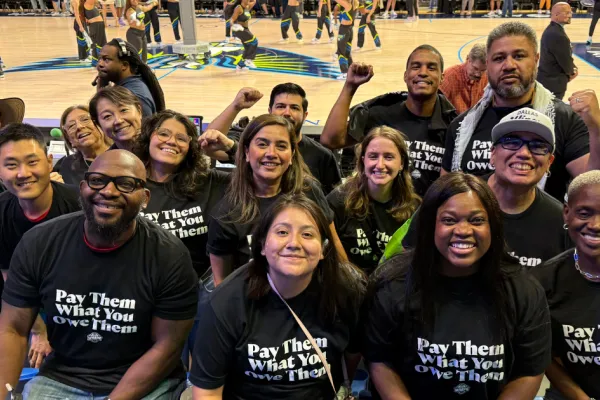 Labor Leaders at the Sept. 11 Dallas Wings game wearing "Pay Them What You Owe Them" t-shirts