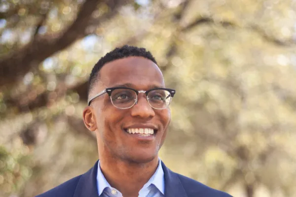 Christian Menefee smiling in the distance 