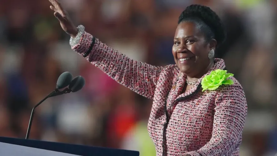 Sheila Jackson Lee waves to the crowd during a speech.