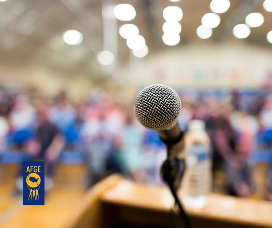 AFGE logo on a photo of a microphone at a town hall