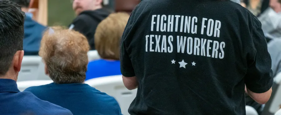 The back of a black t-shirt has the following text in white: "FIGHTING FOR TEXAS WORKERS"