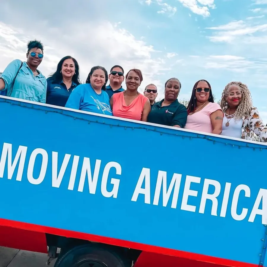 ILA members pose for a photo behind text reading "MOVING AMERICA"
