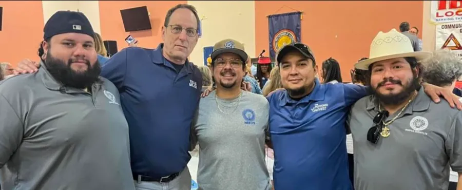 Four union workers in Corpus Christi pose for a group photo with Rick Levy, president of the Texas AFL-CIO