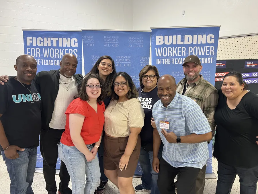 Attendees and facilitators stand for a group photo at an Organizing Institute training session.