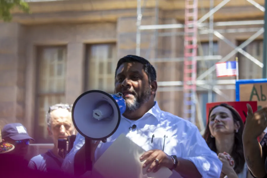 Leonard Aguilar speaks into a megaphone at a rally