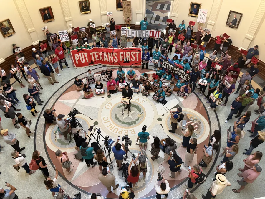 Texans gathered in the Texas Capitol rotunda to protest the Texas House's passing of mid-decade redistricting maps