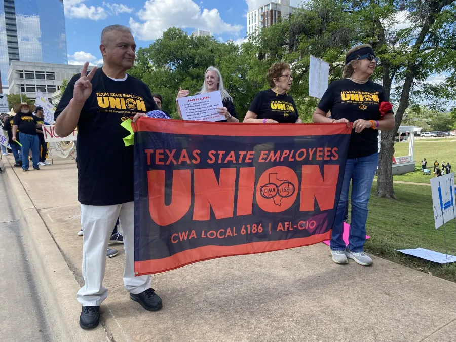 TSEU Members hold their banner