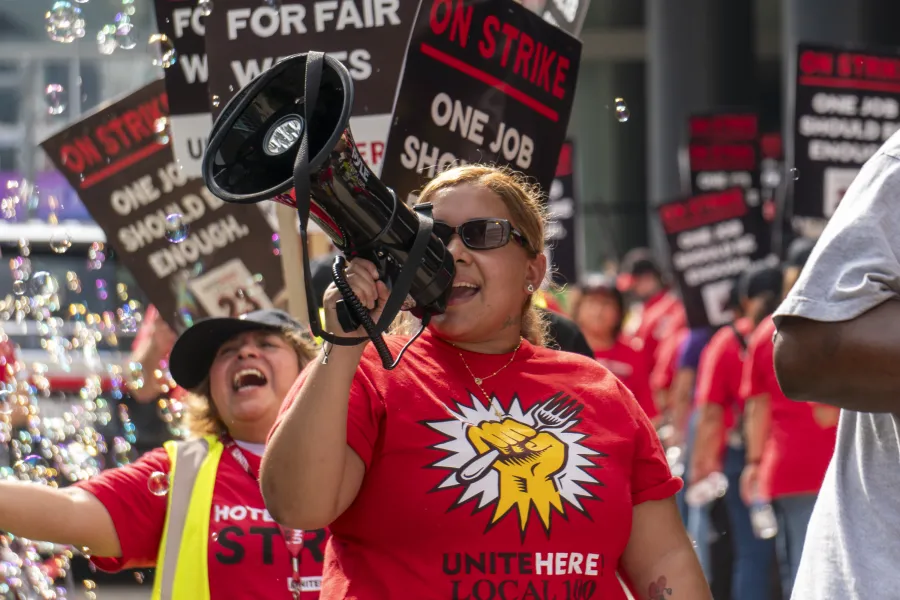 Striking UNITE HERE Local 23 workers are pictured in action on the picket line