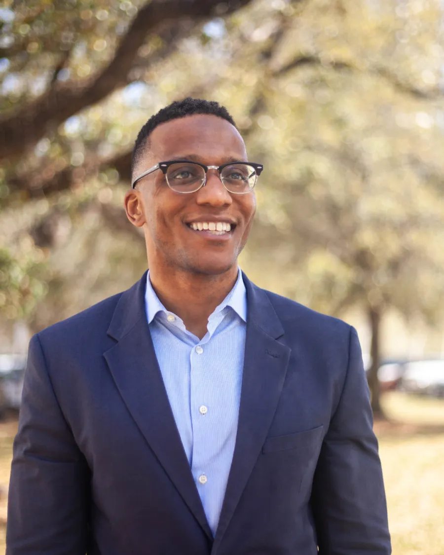 Christian Menefee smiling in the distance 