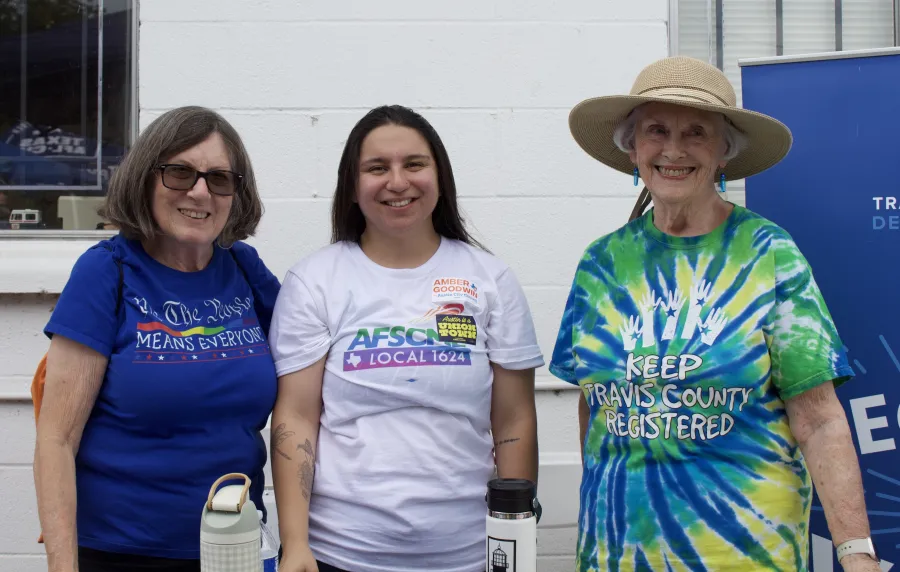 Three volunteer deputy voter registrars pose for a photo