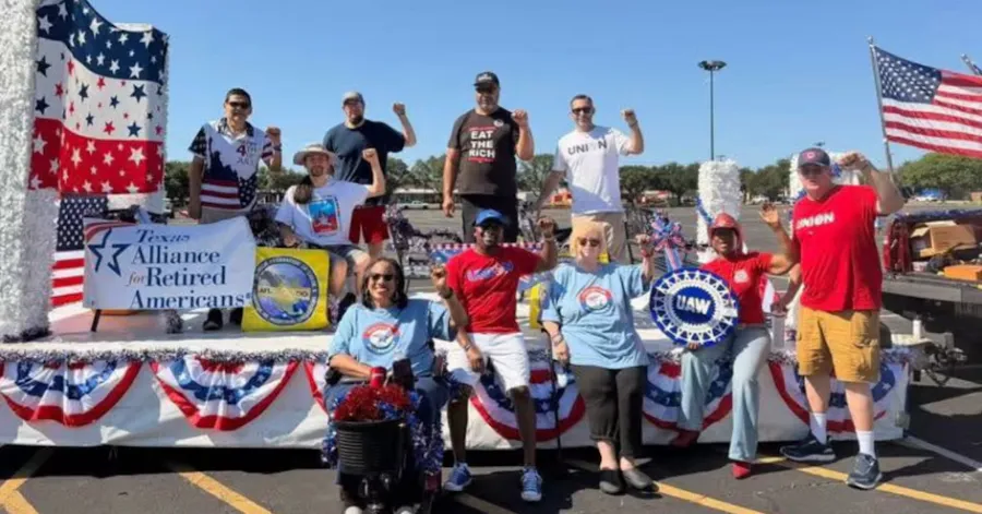 TARA members stand atop a parade float