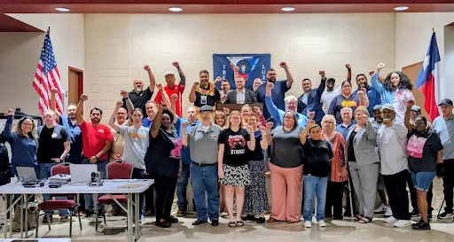 2026 Inaugural Executive Board of the North Texas Area Labor Federation posing for a photo with fists in the air