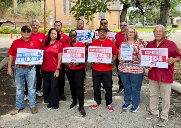 CWA District 6 members, officers, retirees, and constituents from U.S. Congressional District 15 pose for a group photo. They are holding signs demanding a stop to healthcare and medicaid cuts.