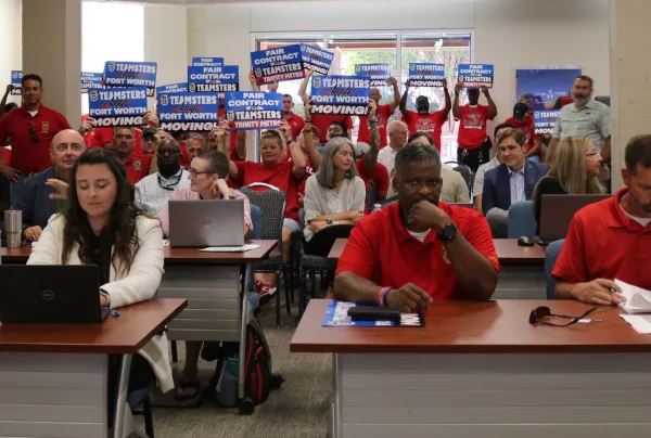 Teamsters Local 767 members hold up signs at the Trinity Metro Board of Directors meeting to show they’re ready for a fair contract.