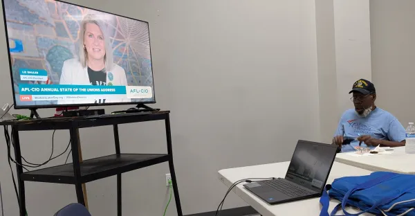 Dallas TARA President Kenneth Williams took notes while Liz Shuler spoke